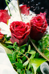 Bouquet of flowers bright red roses and white daisies, macro photo floristry, shop advertising and...