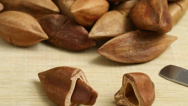 Group of  Philippines pili nuts and a broken one in front close up