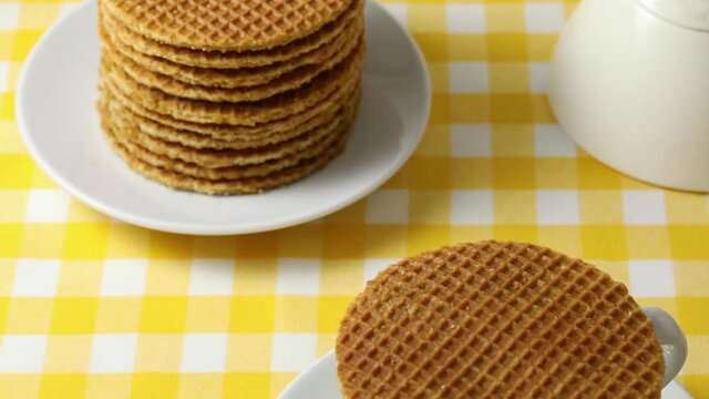 Someone took a bite of a traditional Dutch syrup waffle close up
