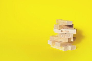 June 9th. Day 9 of month, Calendar date. Wooden blocks folded into the tower with month and day on...