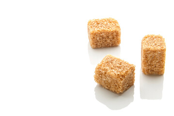 Pieces of natural brown sugar on a white background. copy space