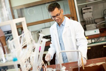 Young researcher checking test tubes