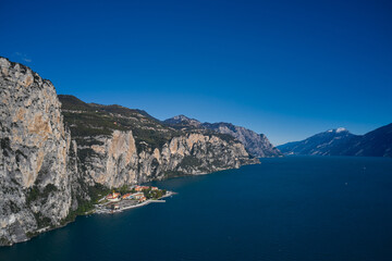 Obraz premium Aerial view at high altitude of the town by the cliff. Town Campione Lake Garda Italy. Panoramic view of the old town of Campione. Italian resort on Lake Garda.