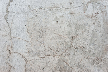 old texture of white gray whitewash street wall in cracks abstract vintage background