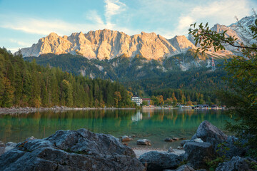lake shore Eibsee with rocks and view to bavarian mountains, zugspitze mass