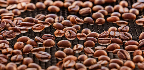 Broken coffee beans, background of roasting coffee beans 