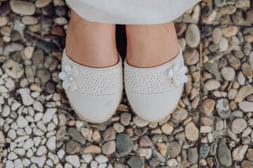 Shoes of a girl dressed for a first communion 