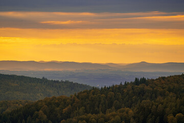 Acolorful sunset in the black forest with a view over Alsace
