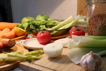 Fresh vegetables for juice preparation: celery, tomatoes, carrots side view