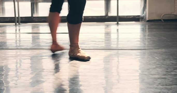 Low section of ballet dancer practicing on tiptoe at dance hall