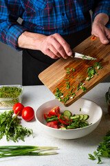 Cooking healthy salad on home kitchen