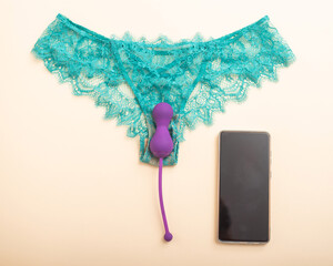 Green lace panties kegel trainer and smartphone. Vibrator synchronized with the application on the...
