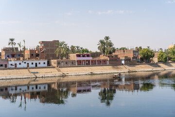 Fototapeta na wymiar Traditional Egyptian villages on the bank of the river Nile. Views sailing on the cruise on the river Nile from Luxor to Aswer, Egypt