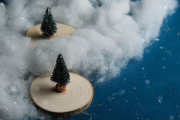 Toy landscape scene with sisal Christmas trees in snow.