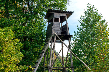 Hunters hut in the forest. Wooden rural watch tower for hunters.
