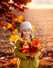 little girl holding orange autumn maple leaves in her hands