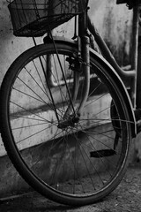 Fototapeta na wymiar Old Bicycle wheel in the village of Vengurla. India. Maharashtra state. Taken on October 26, 2020