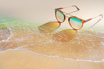 Vintage sunglasses put on the beach.