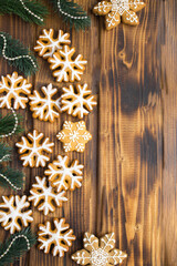 Christmas  composition with gingerbread snowflakes on the  wooden  background. Location vertical.