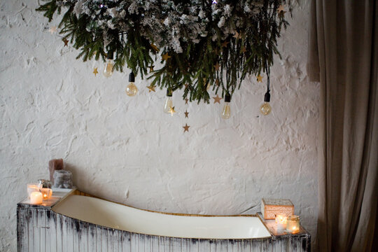 Wooden bathtub with candles and lights