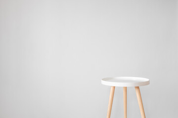 Empty white coffee table in front of grey wall. Scandinavian style, minimalism in house, tranquil...