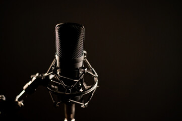 Close-up of a professional microphone for a radio broadcast on a black background. Recording studio...