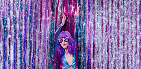 Fashion Lady 80s in stylish holographic party look and tinsel installation. New year's clubbing...