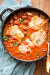 Cod chorizo stew with peas and parsley in tomato sauce 