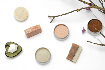 Ingredients for the production of cosmetics on a white background. Clays, wax, herbal powders, dried flowers, raspberry ketone. Natural cosmetics concept.