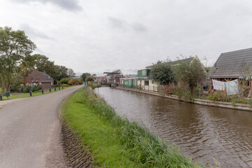 Fototapeta na wymiar Houses along the Winkel river, the Netherlands