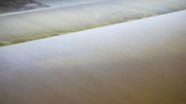 Laser engraving on wood. Laser printer moves on a wooden surface.