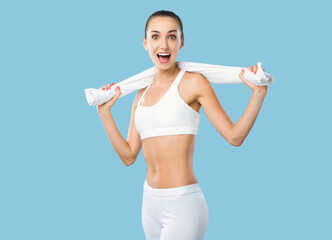 Happy fit woman holding a towel