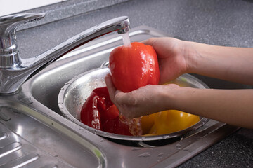 washed red paprika under running water