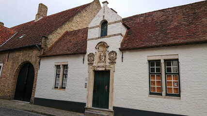 Bruges, Belgium - May 12, 2018:  Roofs And Windows Of Old Authentic Brick Houses On Street Gearwijnstraat