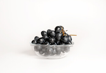 Juicy grapes on a white background in a plate