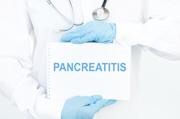 Doctor holds a card with the name of the diagnosis - pancreatitis. Medical concept.