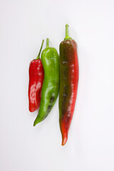 three colored peppers vertical isolated on white