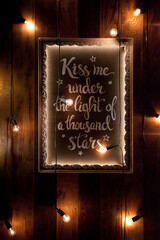 Illuminated wooden plaque, framed with a white picture frame with the inscription 