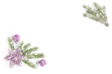 Snowy fir tree branch, pink glitter balls and flower or star on white background. Isolated. Top view with copy space. Flat lay. Christmas background or postcard. New year concept