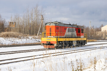 Train in winter. Old diesel locomotive on the railway.