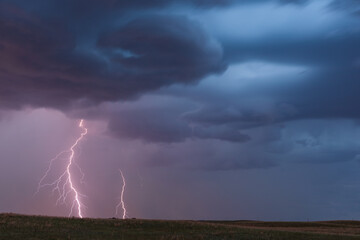 Naklejka na ściany i meble Thunderstorm lightning bolts with storm clouds and dark sky