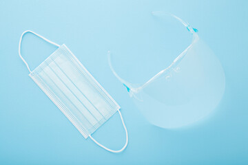New transparent plastic visor with glasses and respirator mask for mouth and nose covering. Light...