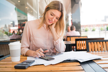 Young businesswoman working at coffee shop.