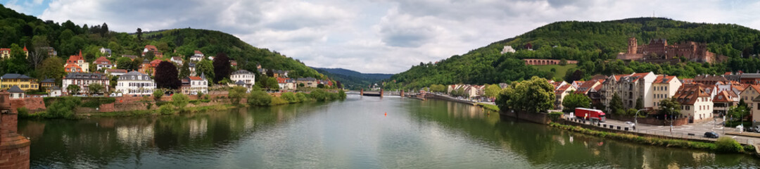 Naklejka na ściany i meble Panorama of the city Heidelberg with river Neckar in the middle and scenic landscape of either side of the river plus the castle on the hill on the right side