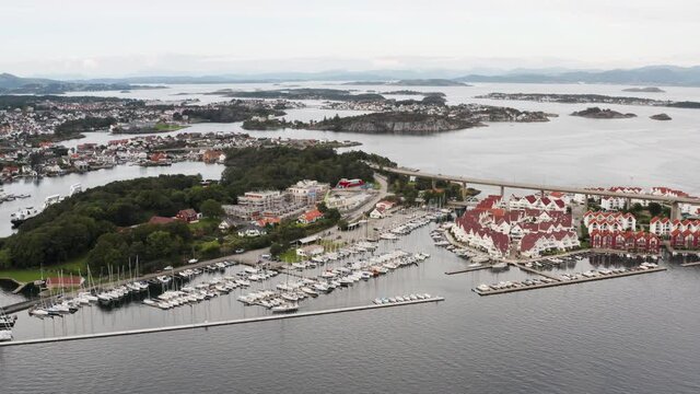 Aerial View of Stavanger City Norway Waterfront, Grasholmen Island, Boats in Marina and Bybrua Road Overpass, Drone Shot