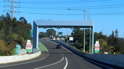 M4 motorway exit to Centenary Drive. Tollgate with overhead scanners and cameras over the exit road