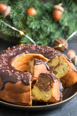 Striped zebra pie, spruce wreath and garland on concrete background.