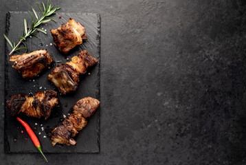 grilled beef ribs on a stone background with copy space for your text