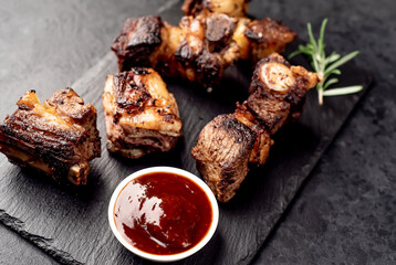 grilled beef ribs on a stone background