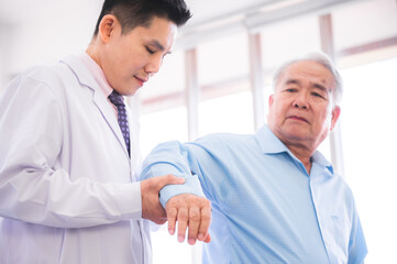 Orthopedist checking for an arm injury of elderly patients in hospital